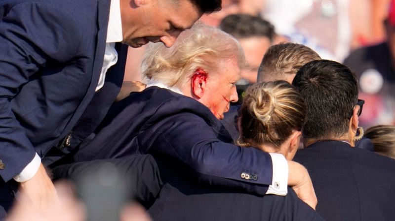 After gunshot Secret Service agents escorted Trump off the stage