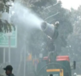 Truck-mount water sprinkler sprays water on roads