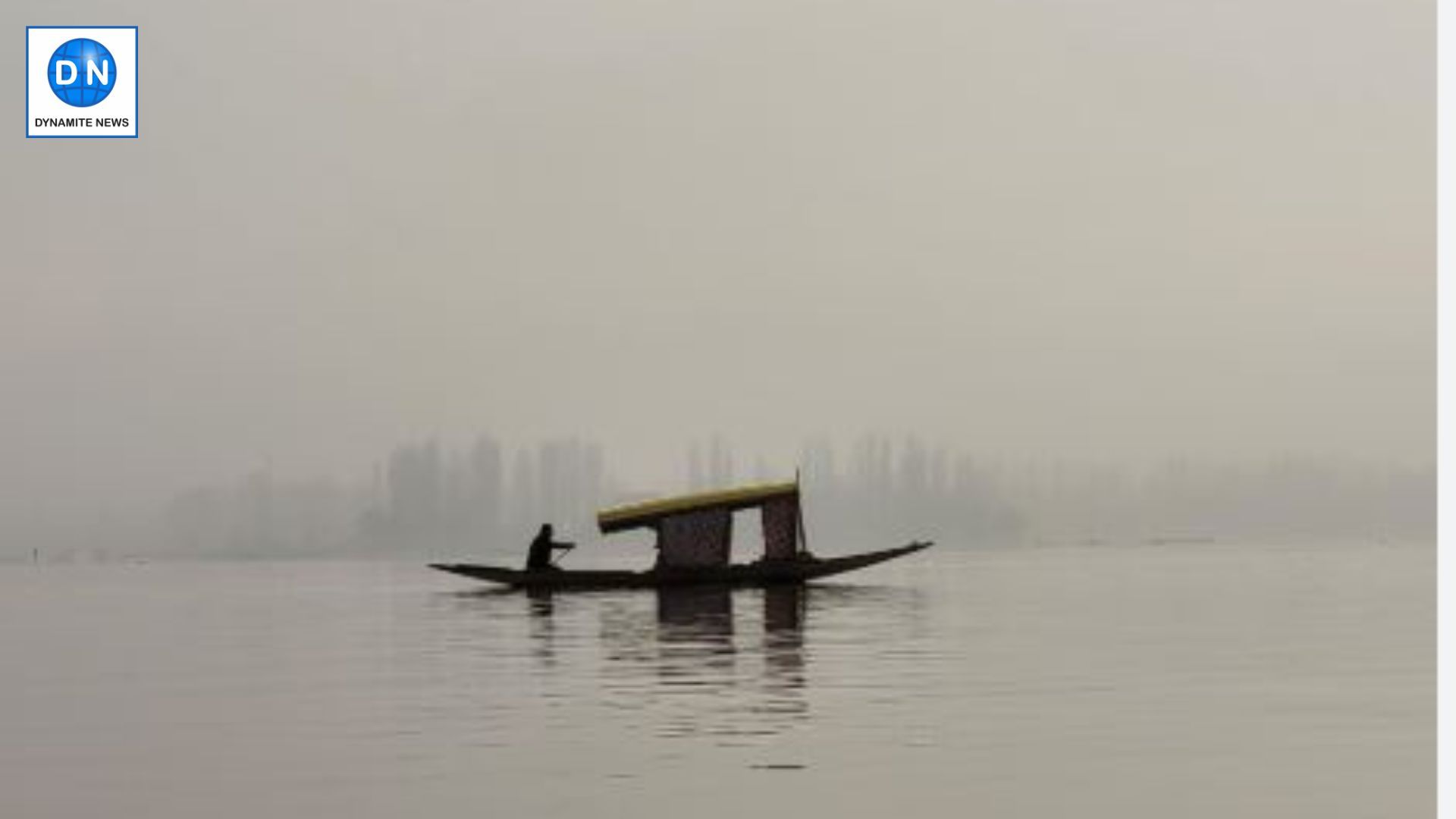 Lone Shikara floating in fog-covered Dal Lake