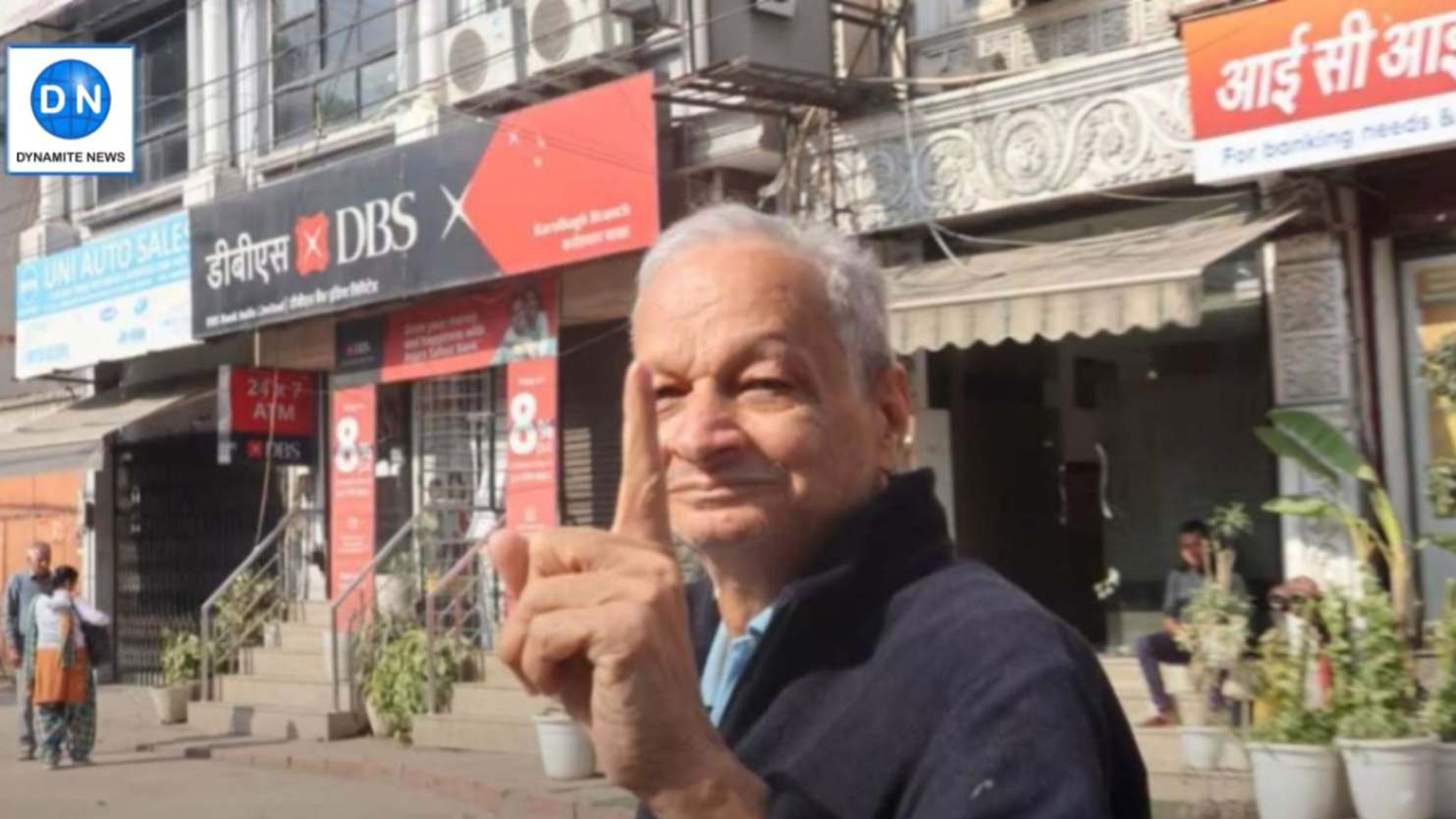 Elderly voter shows his inked finger after casting vote