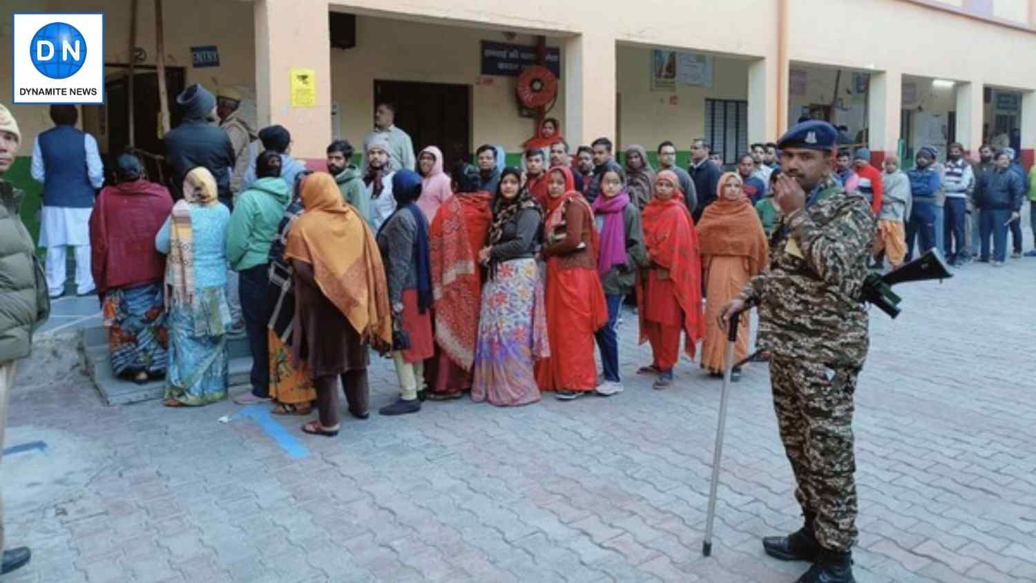 Voters stand in queue at a booth in North-East Delhi